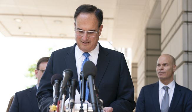 Michael Sussmann, a cybersecurity lawyer who represented the Hillary Clinton presidential campaign in 2016, reads his prepared statement to members of the media outside the federal courthouse in Washington, Tuesday, May 31, 2022. Sussmann was acquitted Tuesday of lying to the FBI when he pushed information meant to cast suspicions on Donald Trump and Russia in the run-up to the 2016 election. (AP Photo/Manuel Balce Ceneta)