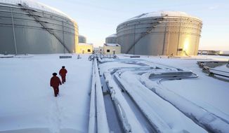 In this photo released by China&#39;s Xinhua News Agency, workers inspect the pipelines and oil storage tanks of a nearly 625-miles-long China and Russia crude oil pipeline in Mohe, northeast China&#39;s Heilongjiang Province on Jan. 1, 2011. China’s support for Russia through oil and gas purchases is irking Washington and raising the risk of U.S. retaliation, foreign observers say, though they see no sign Beijing is helping Moscow evade sanctions over its war on Ukraine. (Wang Jianwei/Xinhua via AP, File)