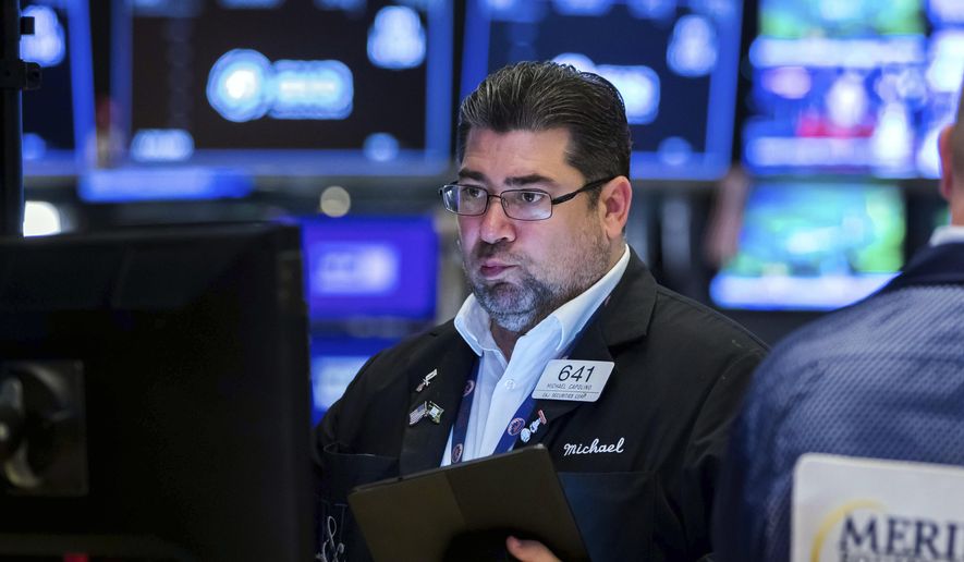 In this photo provided by the New York Stock Exchange, trader Michael Capolino works on the floor, Tuesday, May 31, 2022. U.S. stocks are slipping in midday trading on Tuesday, as Wall Street nears the end of a tumultuous month, bruised by worries about a possible recession, inflation and rising interest rates. (Courtney Crow/New York Stock Exchange via AP)