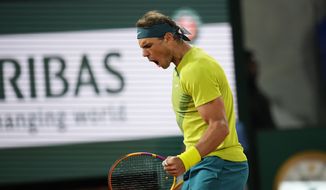 Spain&#39;s Rafael Nadal clenches his fist after scoring a point against Serbia&#39;s Novak Djokovic during their quarterfinal match at the French Open tennis tournament in Roland Garros stadium in Paris, France, Tuesday, May 31, 2022. (AP Photo/Christophe Ena)