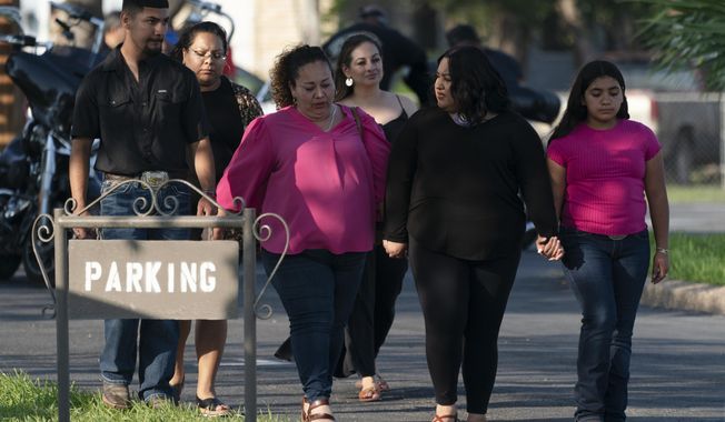 People leave a funeral home after attending a visitation for Amerie Garza, a 10-year-old victim who was killed in last week&#x27;s elementary school shooting in Uvalde, Texas, Monday, May 30, 2022. (AP Photo/Jae C. Hong)