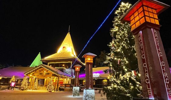 The Santa Claus Village tourist attraction lit with festive lights early in the morning in Rovaniemi, Finland on Dec. 4, 2021.  (AP Photo/James Brooks)