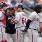 Washington Nationals manager Dave Martinez, second from left, hands the ball to relief pitcher Victor Arano (64) after relieving starting pitcher Evan Lee in the fourth inning of a baseball game against the New York Mets, Wednesday, June 1, 2022, in New York. (AP Photo/John Minchillo)