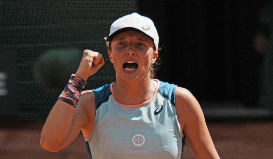 Poland&#39;s Iga Swiatek clenches her fist after defeating Jessica Pegula of the U.S. during their quarterfinal match of the French Open tennis tournament at the Roland Garros stadium Wednesday, June 1, 2022 in Paris. Swiatek won 6-3, 6-2. (AP Photo/Thibault Camus)