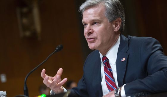 Director of the Federal Bureau of Investigation Christopher Wray testifies during a Senate Appropriations Subcommittee hearing on the fiscal year 2023 budget for the FBI in Washington, DC on Wednesday, May 25, 2022. (Bonnie Cash/Pool Photo via AP)