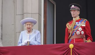 Queen Elizabeth II and the Duke of Kent watch from the balcony during the Trooping the Color ceremony at Horse Guards Parade in London, Thursday, June 2, 2022, on the first of four days of celebrations to mark the Platinum Jubilee. The events over a long holiday weekend in the U.K. are meant to celebrate the monarch’s 70 years of service. (Jonathan Brady/Pool Photo via AP)