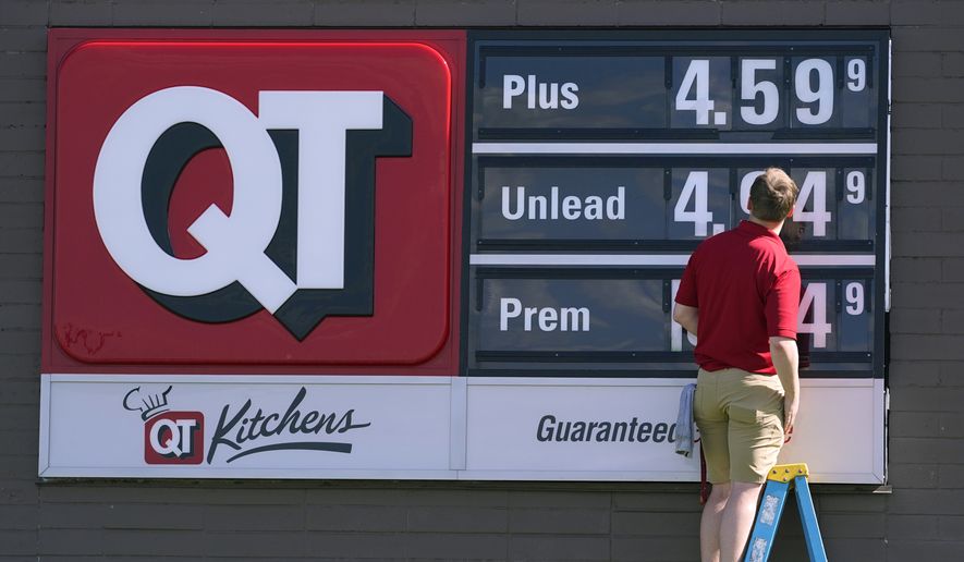 A worker changes the gasoline price sign at a QuikTrip, Thursday, June 2, 2022, in Des Moines, Iowa. (AP Photo/Charlie Neibergall) **FILE**