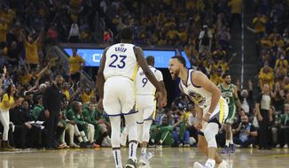 Golden State Warriors guard Stephen Curry, right, celebrates with forward Draymond Green (23) during the first half of Game 1 of basketball&#39;s NBA Finals against the Boston Celtics in San Francisco, Thursday, June 2, 2022. (AP Photo/Jed Jacobsohn)