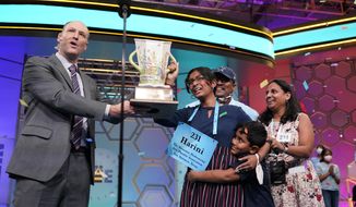 Harini Logan, 14, from San Antonio, Texas, celebrates winning the Scripps National Spelling Bee with Scripps CEO Adam Sampson right and family stage Thursday, June 2, 2022, in Oxon Hill, Md. (AP Photo/Alex Brandon)