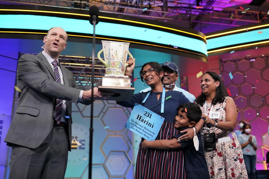 Harini Logan, 14, from San Antonio, Texas, celebrates winning the Scripps National Spelling Bee with Scripps CEO Adam Sampson right and family stage Thursday, June 2, 2022, in Oxon Hill, Md. (AP Photo/Alex Brandon)