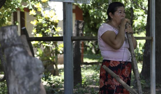 Maria Dolores Garcia, the mother of Esmeralda Dominguez, looks out at the plants dying in her daughter’s unattended garden, in the Sisiguayo community in Jiquilisco, in the Bajo Lempa region of El Salvador, Thursday, May 12, 2022. Her daughter is among thousands arrested since the congress granted President Nayib Bukele a state of emergency declaration suspending civil liberties after street gangs killed dozens of people in late March. (AP Photo/Salvador Melendez)