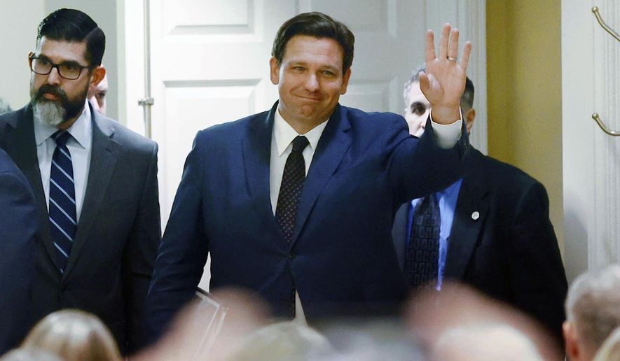 Florida Gov. Ron DeSantis waves as he arrives to signs a record $109.9 billion state budget Thursday, June, 2, 2022 at The Villages, Fla. Florida Gov. Ron DeSantis on Thursday signed a $109.9 billion state budget bill that includes pay raises for state workers and law enforcement, as well as tax suspensions on gas, diapers and school supplies. (Stephen M. Dowell/Orlando Sentinel via AP)