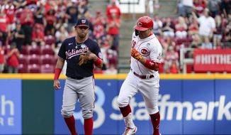 Cincinnati Reds&#39; Joey Votto runs the bases next to Washington Nationals shortstop Luis Garcia after hitting a three-run home run during the first inning of a baseball game Thursday, June 2, 2022, in Cincinnati. (AP Photo/Jeff Dean)