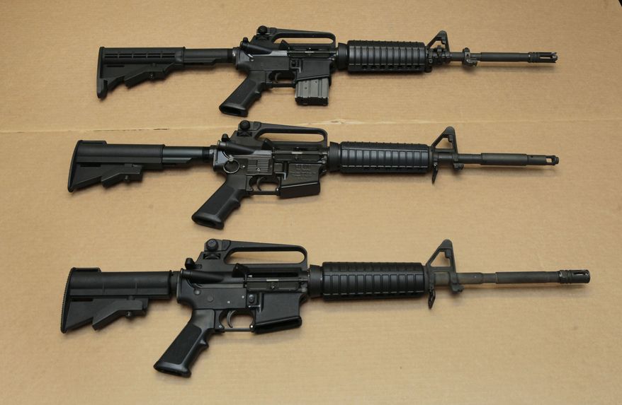 Three variations of the AR-15 assault rifle are displayed at the California Department of Justice in Sacramento, Calif., on Aug. 15, 2012. (AP Photo/Rich Pedroncelli, File)