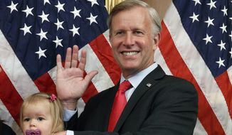 Congressman Chris Jacobs, R-N.Y., center, poses for a photo with his daughter Anna, 1, during a ceremonial swearing-in on Capitol Hill, July 21, 2020, in Washington. Jacobs says he will not run for another term in Congress amid backlash over his support for new gun control measures. (AP Photo/Jacquelyn Martin, File)