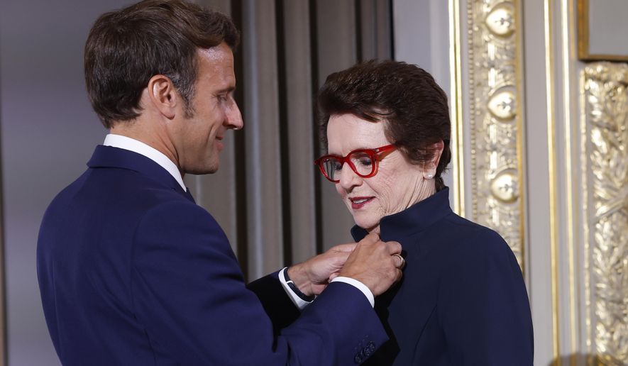 French President Emmanuel Macron awards tennis legend Billie Jean King, of the U.S, with the Legion d&#39;Honneur at the Elysee Palace Friday, June 3, 2022 in Paris. A ceremony Thursday at the Roland Garros stadium marked the 50th anniversary of her French Open win.(AP Photo/Jean-Francois Badias, Pool)