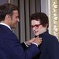 French President Emmanuel Macron awards tennis legend Billie Jean King, of the U.S, with the Legion d&#39;Honneur at the Elysee Palace Friday, June 3, 2022 in Paris. A ceremony Thursday at the Roland Garros stadium marked the 50th anniversary of her French Open win.(AP Photo/Jean-Francois Badias, Pool)