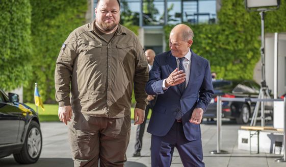 German Chancellor Olaf Scholz, right, welcomes Ukrainian Parliament Speaker Ruslan Stefanchuk, left, for a meeting at the chancellery in Berlin, Germany, Friday, June 3, 2022. (Michael Kappeler/dpa via AP)