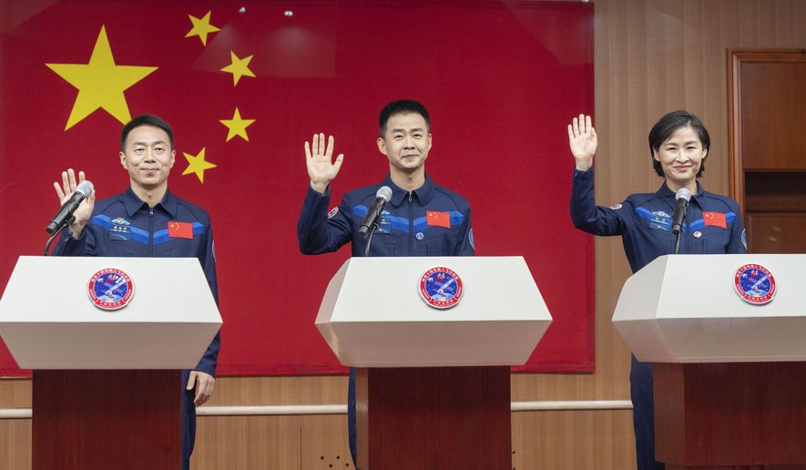 In this photo released by Xinhua News Agency, Chinese astronauts from left Cai Xuzhe, Chen Dong and Liu Yang, right, wave as they attend a press conference for the upcoming Shenzhou-14 mission at the Jiuquan Satellite Launch Center in northwestern China on Saturday, June 4, 2022. China is preparing to launch a new three-person mission to complete work on its permanent orbiting space station, the country&#39;s China Manned Space Agency said Saturday. (Cai Yang/Xinhua via AP)