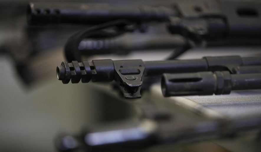 Illegally possessed firearms seized by authorities are displayed during a news conference Oct. 9, 2018, in Los Angeles. As Americans reel from repeated shootings, law enforcement officials and experts on extremism are taking increasing notice of the sprawling online space devoted to guns and gun rights: gun forums, tactical training videos, websites that sell unregistered gun kits and social media platforms where far-right gun owners swap practical tips with talk of dark plots to take their weapons. (AP Photo/Jae C. Hong, File)
