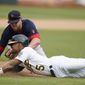 Boston Red Sox third baseman Bobby Dalbec, top, tags out Oakland Athletics&#39; Tony Kemp (5) at third during the eighth inning of a baseball game in Oakland, Calif., Saturday, June 4, 2022. (AP Photo/Jeff Chiu)
