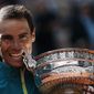 Spain&#39;s Rafael Nadal bites the cup after defeating Norway&#39;s Casper Ruud in their final match of the French Open tennis tournament at the Roland Garros stadium Sunday, June 5, 2022 in Paris. Nadal won 6-3, 6-3, 6-0. (AP Photo/Thibault Camus)