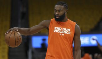 Boston Celtics guard Jaylen Brown wears a shirt that reads End Gun Violence while warming up before Game 2 of basketball&#39;s NBA Finals against the Golden State Warriors in San Francisco, Sunday, June 5, 2022. (AP Photo/Jed Jacobsohn)