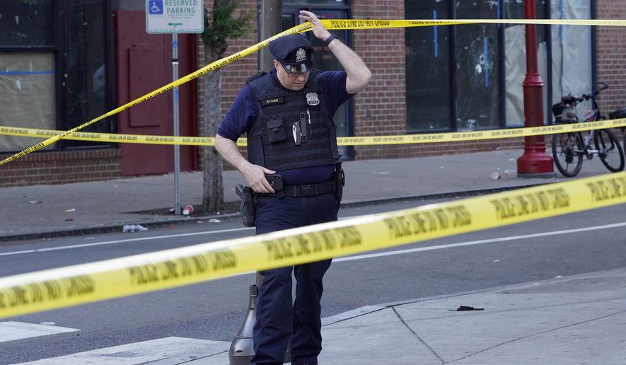 Philadelphia Police investigators work the scene of a fatal overnight shooting on South Street in Philadelphia, Sunday, June 5, 2022. (AP Photo/Michael Perez)