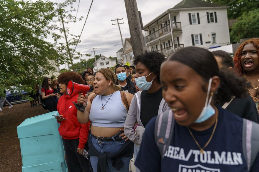 Students from Shea High School shout the names of those killed in last week's school shooting in Uvalde, Texas, as they pause during their walkout to protest the nation's gun policies, Wednesday, June 1, 2022, in Pawtucket, R.I. Organizer Zachary Pinto, 17, said his fellow students told them they were frustrated, angry and in pain after last week's school shooting. He led students to a rally at city hall where they were then joined by other local high school students. (AP Photo/David Goldman)