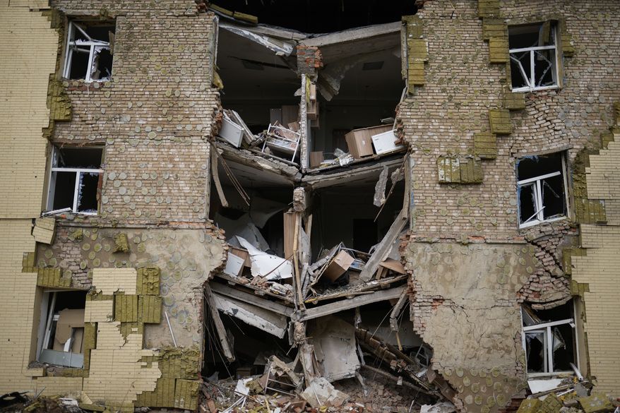 Debris hangs from a residential building heavily damaged in a Russian bombing in Bakhmut, eastern Ukraine, eastern Ukraine, Saturday, May 28, 2022. Fighting has raged around Lysychansk and neighboring Sievierodonetsk, the last major cities under Ukrainian control in Luhansk region. (AP Photo/Francisco Seco) ** FILE **