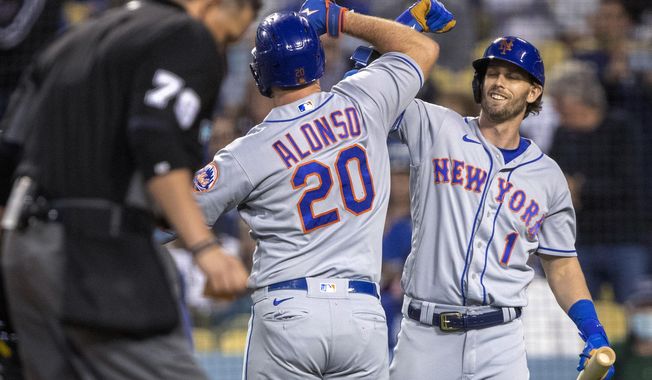 New York Mets&#x27; Jeff McNeil, right, congratulates Pete Alonso, who hit a two-run home run against the Los Angeles Dodgers during the third inning of a baseball game in Los Angeles, Saturday, June 4, 2022. (AP Photo/Alex Gallardo)