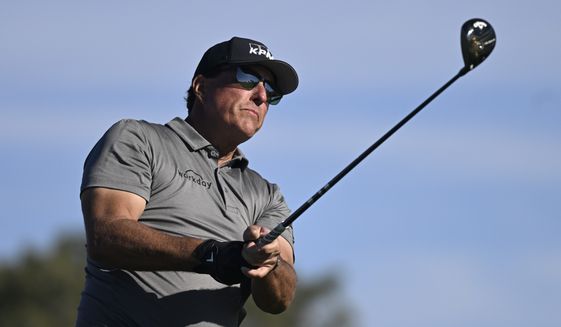 Phil Mickelson hits his tee shot on the fifth hole of the South Course at Torrey Pines during the first round of the Farmers Insurance Open golf tournament, Jan. 26, 2022, in San Diego. Phil Mickelson, the chief recruiter for a Saudi-funded rival league to the PGA Tour, was the last big name to join the 48-man field for the LIV Golf Invitational that starts Friday outside London. It will be Mickelson&#x27;s first time playing since Feb. 6 at the Saudi International. (AP Photo/Denis Poroy, File)