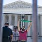 An abortion rights demonstrator chains himself by the neck to an anti-scaling fence as he protests Monday, June 6, 2022, outside the Supreme Court in Washington. (AP Photo/Jacquelyn Martin) **FILE**