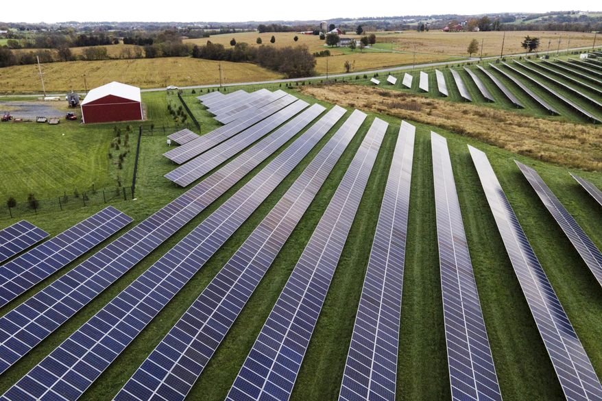 Farmland is seen with solar panels from Cypress Creek Renewables, Oct. 28, 2021, in Thurmont, Md. President Joe Biden plans to invoke the Defense Production Act to increase U.S. manufacturing of solar panels while declaring a two-year tariff exemption on panels from Southeast Asia. (AP Photo/Julio Cortez, File)