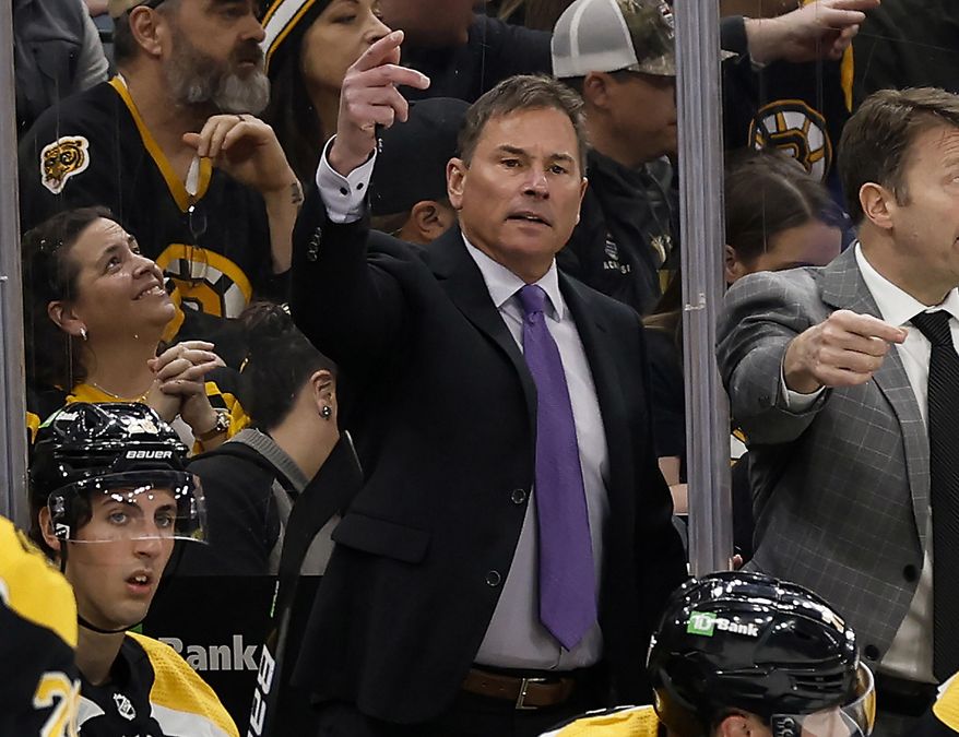 Boston Bruins head coach Bruce Cassidy, center, gestures during the third period of an NHL hockey game against the Pittsburgh Penguins, April 16, 2022, in Boston. The Bruins have fired Cassidy several weeks after losing in the first round of the playoffs. (AP Photo/Winslow Townson, File) **FILE**