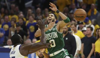 Boston Celtics forward Jayson Tatum (0) loses the ball while being defended by Golden State Warriors forward Draymond Green (23) and guard Stephen Curry during the second half of Game 2 of basketball&#39;s NBA Finals in San Francisco, Sunday, June 5, 2022. (AP Photo/Jed Jacobsohn) **FILE**