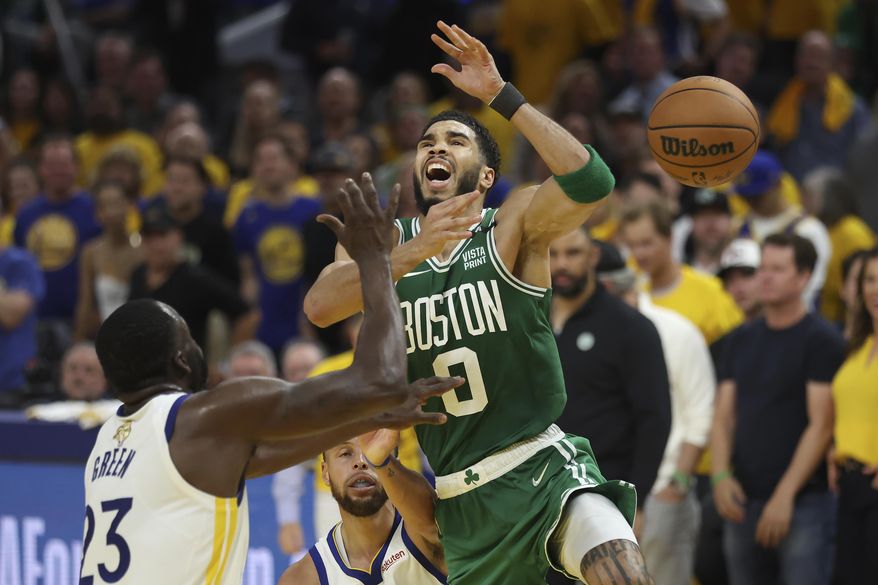 Boston Celtics forward Jayson Tatum (0) loses the ball while being defended by Golden State Warriors forward Draymond Green (23) and guard Stephen Curry during the second half of Game 2 of basketball&#39;s NBA Finals in San Francisco, Sunday, June 5, 2022. (AP Photo/Jed Jacobsohn) **FILE**