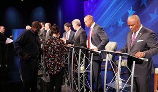 From right, Rushern Baker, Wes Moore, Doug Gansler and Jon Baron stand at their podiums just before a debate of eight candidates seeking the Democratic nomination for governor of Maryland on Monday, June 6, 2022 in Owings Mills, Md. (AP Photo/Brian Witte)