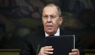 Russian Foreign Minister Sergey Lavrov holds documents during a press conference in Moscow, Russia, Friday, April 8, 2022. Serbia says that a planned visit by Russia&#39;s foreign minister to the Balkan country will not take place. The announcement followed reports that Serbia&#39;s neighbors, Bulgaria, North Macedonia and Montenegro refused to allow Lavrov&#39;s plane to fly through their airspace to reach Serbia. (AP Photo/Alexander Zemlianichenko, Pool)