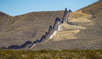 A U.S. government-built section of border wall snakes through the Sonoran Desert just west of the San Bernardino National Wildlife Refuge, separating Mexico, left, and the United States, Dec. 9, 2020, in Douglas, Ariz. A prosecutor told jurors in closing arguments at a criminal trial, Tuesday, May 31, 2022, that there is overwhelming evidence that organizers of a &amp;quot;We Build The Wall&amp;quot; campaign to raise money for a wall along the U.S. southern border defrauded investors. (AP Photo/Matt York, File)