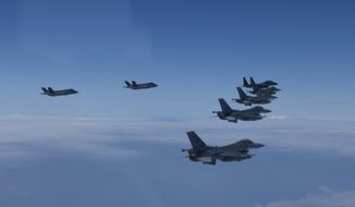 In this photo provided by South Korea Defense Ministry, U.S. and South Korea Air Force fighter jets fly in formation during a joint drill on Tuesday, June, 7, 2022. The South Korean and U.S. militaries flew 20 fighter jets over South Korea&#39;s western sea Tuesday in a continued show of force as a senior U.S. official warned of a forceful response if North Korea goes ahead with its first nuclear test explosion in nearly five years. (South Korea Defense Ministry via AP)