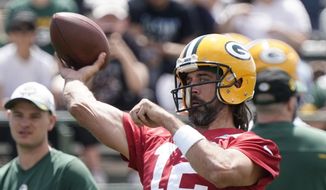 Green Bay Packers&#39; Aaron Rodgers runs a drill at the NFL football team&#39;s practice field Tuesday, June 7, 2022, in Green Bay, Wis. (AP Photo/Morry Gash)