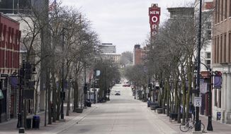 FILE - In this April 15, 2020 file photo, State Street is mostly empty around noontime due to the coronavirus pandemic in Madison, Wis. A divided Wisconsin Supreme Court on Tuesday, June 7, 2022 said the state health department can release data on coronavirus outbreak cases, information sought two years ago near the beginning of the pandemic. (Steve Apps/Wisconsin State Journal via AP, file)
