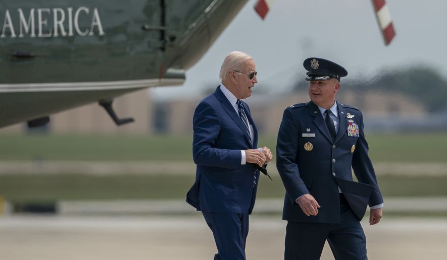 President Joe Biden, escorted by Colonel Matthew Jones, Commander, 89th Airlift Wing walks to board Air Force One for a trip to Los Angeles to attend the Summit of the Americas, Wednesday, June 8, 2022, at Andrews Air Force Base, Md. (AP Photo/Gemunu Amarasinghe)