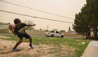 Chrisstavion Reese, 7, plays catch with his uncle Jay&#39;shin Williams in the midst of a dust storm Wednesday, June 8, 2022, in Odessa, Texas. The National Weather Service has issued a hazardous weather outlook for southeast New Mexico, southwest Texas and western Texas that will last through Tuesday. Day one of the outlook warns of blowing dust and a potential for severe storms that will be accompanied by large hail and damaging winds. Days two through seven of the outlook warn of a heatwave that will continue Friday through Tuesday. (Eli Hartman/Odessa American via AP) **FILE**