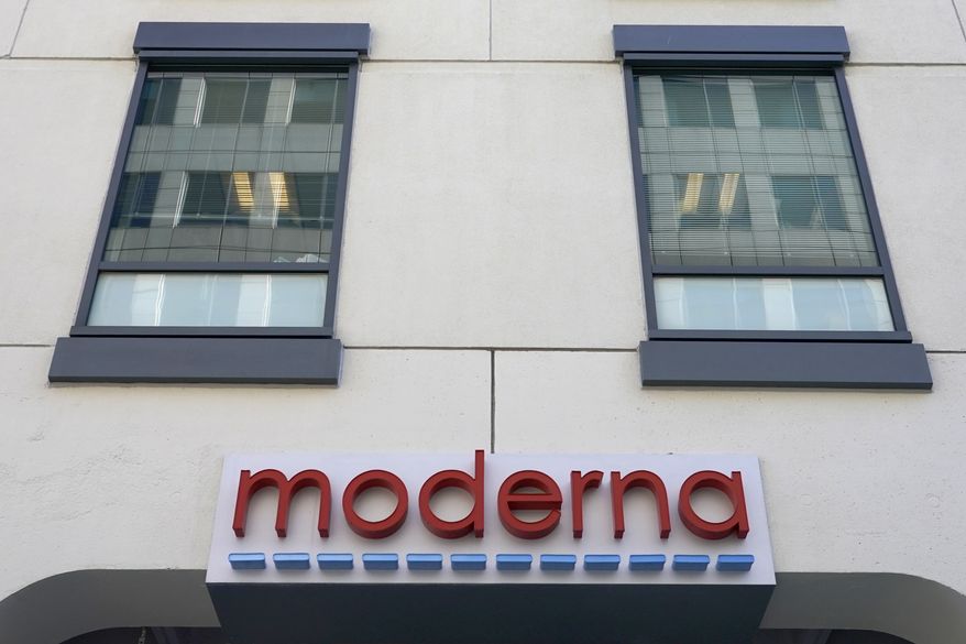 In this Dec. 15, 2020, file photo, a sign for Moderna, Inc. hangs on its headquarters in Cambridge, Mass.  Moderna&#39;s experimental COVID-19 vaccine that combines its original shot with protection against the omicron variant appears to work, the company announced Wednesday, June 8, 2022.  COVID-19 vaccine makers are studying updated boosters that might be offered in the fall to better protect people against future coronavirus surges.(AP Photo/Elise Amendola, File)