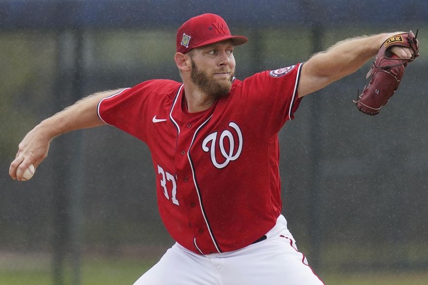FILE - Washington Nationals pitcher Stephen Strasburg throws live batting practice in a drizzle during the team&#x27;s spring training baseball workout March 15, 2022, in West Palm Beach, Fla. Strasburg is scheduled to make his season debut against the Miami Marlins on Thursday. The 33-year-old Strasburg has been sidelined for most of the past two seasons. He underwent surgery for thoracic outlet syndrome last summer and has not pitched since June 1, 2021. (AP Photo/Sue Ogrocki, File)