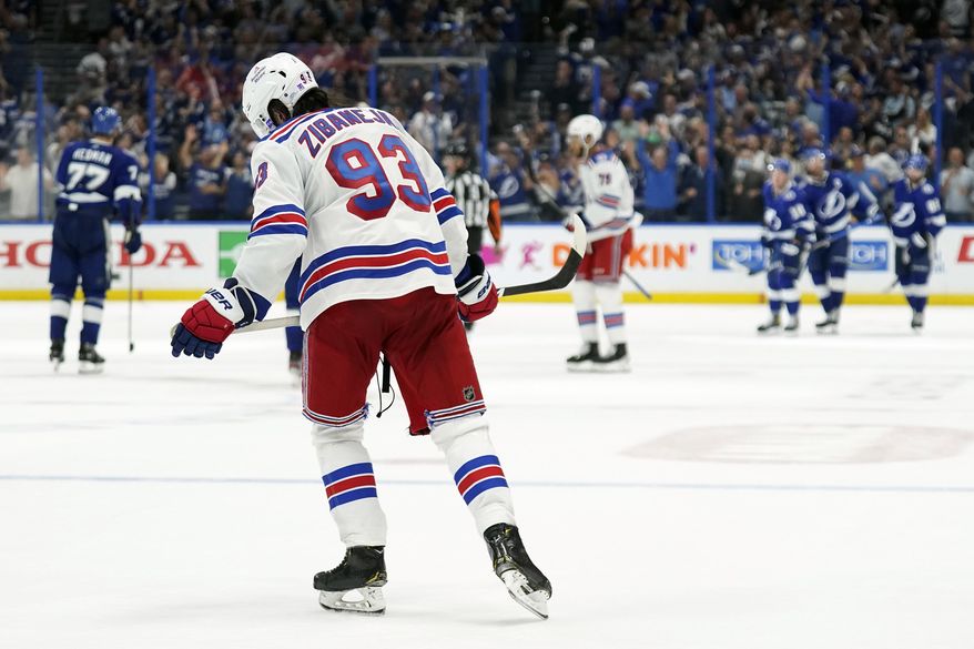 New York Rangers center Mika Zibanejad (93) skates off as members of the Tampa Bay Lightning celebrate a goal by Ondrej Palat during the third period in Game 4 of the NHL hockey Stanley Cup playoffs Eastern Conference finals Tuesday, June 7, 2022, in Tampa, Fla. (AP Photo/Chris O&#x27;Meara) ** FILE**