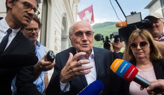 Former FIFA president Sepp Blatter is surrounded by the media as he leaves the Swiss Federal Criminal Court in Bellinzona, Switzerland, Wednesday, June 8, 2022. Blatter and former UEFA president Michel Platini have arrived at a Swiss criminal court for their 11-day trial on charges of defrauding FIFA, the world governing body of soccer. (Alessandro Crinari/Keystone via AP) **FILE**
