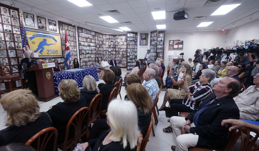 Sylvia Iriondo, left rear, president of Mothers and Women Against Repression, speaks at a news conference along with other Cuban exiles, of their concern of the sale of two local Spanish language radio stations, Wednesday, June 8, 2022, at the Bay of Pigs Museum and Brigade 2506 headquarters in Miami&#x27;s Little Havana neighborhood. The deal involving Spanish-language radio stations is stirring up opposition in Miami, where Cuban exiles describe it as a clear attempt by Democrats to stifle conservative and anti-Communist voices in the Hispanic community where they&#x27;ve lost ground. (AP Photo/Wilfredo Lee) ** FILE **